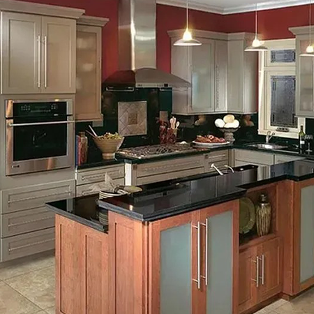 Kitchen remodel with gray shaker cabinets, a cherry-wood island and black granite countertops