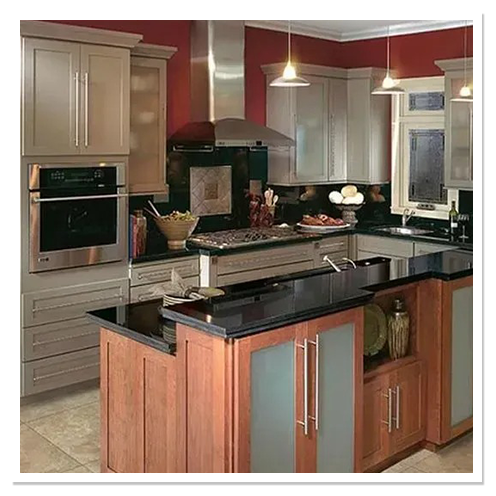 Kitchen with gray shaker cabinets, a cherry-wood island with frosted-glass doors and black granite countertops