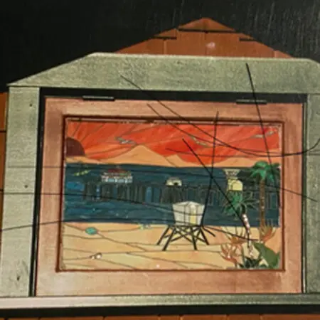 Stained-glass window of a beach, pier and lifeguard tower set in a home's gable